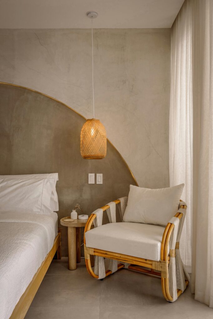 Chic bedroom interior featuring rattan furniture and warm lighting for a soothing ambiance.